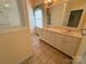 Well-lit bathroom featuring double sinks, a large mirror, and tiled floors for a functional space at 1419 Ridge St, Albemarle, NC 28001