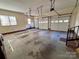 Spacious garage with three bays, concrete floor, and natural light through a window at 1419 Ridge St, Albemarle, NC 28001