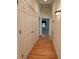 Hallway with wood floors, closet, and access to other rooms at 1419 Ridge St, Albemarle, NC 28001