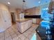 Traditional kitchen features a center island, granite countertops, and tile flooring at 1419 Ridge St, Albemarle, NC 28001