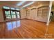 Bright living room featuring hardwood floors, built-in shelving, and large windows with natural light at 1419 Ridge St, Albemarle, NC 28001