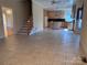 Spacious living room adjacent to the kitchen with tile flooring and staircase at 1419 Ridge St, Albemarle, NC 28001