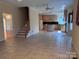 Open living space with tile floors, connecting the kitchen and staircase at 1419 Ridge St, Albemarle, NC 28001