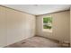 Bedroom view showcasing a bright window overlooking the outdoors at 143 Lakewind Dr, Mooresville, NC 28115
