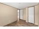 A neutral bedroom features a plank floor and a view to another room at 143 Lakewind Dr, Mooresville, NC 28115