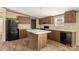 This kitchen features an island, wood cabinets, modern appliances, and great natural light at 143 Lakewind Dr, Mooresville, NC 28115