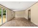Bright living room with a sliding glass door provides access to the outdoor deck and yard at 143 Lakewind Dr, Mooresville, NC 28115