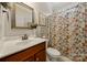 Bathroom with decorative shower curtain, bronze fixtures and framed mirror at 1736 Townsend Ln, Rock Hill, SC 29730