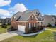 Beautifully landscaped home with a brick and siding exterior, showcasing a well-maintained lawn and inviting curb appeal at 1736 Townsend Ln, Rock Hill, SC 29730