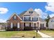 Charming two-story home featuring a combination of brick and siding, complemented by a well-manicured lawn and lush landscaping at 1736 Townsend Ln, Rock Hill, SC 29730