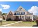 Inviting two-story home with brick and siding, enhanced by a green lawn, mature landscaping, and a welcoming entrance at 1736 Townsend Ln, Rock Hill, SC 29730