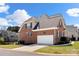 Brick two-story home featuring a two car garage and well maintained landscaping at 1736 Townsend Ln, Rock Hill, SC 29730