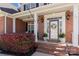 Charming front porch with brick columns, decorative plants, and a welcoming entrance with a floral wreath at 1736 Townsend Ln, Rock Hill, SC 29730