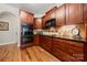 Gourmet kitchen featuring cherry cabinets, built-in appliances, and hardwood floors at 1736 Townsend Ln, Rock Hill, SC 29730