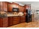 Modern kitchen features wood cabinets, black countertops, diamond pattern backsplash and stainless steel appliances at 1736 Townsend Ln, Rock Hill, SC 29730