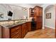 Modern kitchen with cherry cabinets, granite counters, and hardwood flooring at 1736 Townsend Ln, Rock Hill, SC 29730