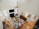 Open concept living room with fireplace, television, ceiling fan and hardwood floors at 1736 Townsend Ln, Rock Hill, SC 29730