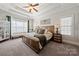 The main bedroom features a tray ceiling, a ceiling fan and a large window with a bench at 1736 Townsend Ln, Rock Hill, SC 29730