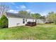 Backyard view showcasing the home's siding, a wooden deck, and a detached garage at 301 N 4Th Ave, Maiden, NC 28650