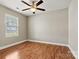 This bedroom has vinyl floors, a ceiling fan, and a window that allows natural light at 301 N 4Th Ave, Maiden, NC 28650