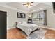 Cozy bedroom with tray ceilings, wood floors, a decorative rug, and large window at 301 N 4Th Ave, Maiden, NC 28650