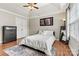 Bedroom with tray ceilings, wood floors, and neutral walls, with a decorative rug and natural light at 301 N 4Th Ave, Maiden, NC 28650