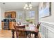 Dining area with wooden table and chairs next to a kitchen with wooden cabinets and stainless steel appliances at 301 N 4Th Ave, Maiden, NC 28650