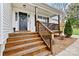 Inviting front porch with wooden stairs and railings, creating a warm welcome at 301 N 4Th Ave, Maiden, NC 28650