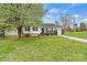 Charming home features a front porch and a lush green lawn, creating an inviting curb appeal at 301 N 4Th Ave, Maiden, NC 28650