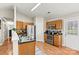 Bright kitchen featuring stainless steel appliances, wood cabinets, black countertops, and light wood flooring at 301 N 4Th Ave, Maiden, NC 28650