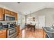 Kitchen with stainless steel appliances, wooden cabinets, dining table, and plenty of natural light at 301 N 4Th Ave, Maiden, NC 28650