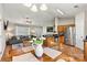 Open floor plan featuring a living room with a large gray couch adjacent to a kitchen with stainless steel appliances at 301 N 4Th Ave, Maiden, NC 28650