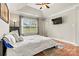 Bright main bedroom featuring a tray ceiling, fan, and large window, creating a relaxing retreat at 301 N 4Th Ave, Maiden, NC 28650