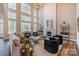 Bright living room features soaring windows, fireplace, neutral tones, and elegant furnishings at 6066 Jepson Ct, Charlotte, NC 28214