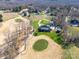 Picturesque aerial view of a home on a golf course with mature landscaping and pool at 810 Lake Wright Rd, China Grove, NC 28023