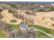 Stunning aerial view of an estate on a golf course with mature trees and landscaping at 810 Lake Wright Rd, China Grove, NC 28023
