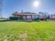 Expansive backyard featuring a well-manicured lawn and brick home with manicured landscaping at 810 Lake Wright Rd, China Grove, NC 28023