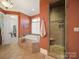 Spa bathroom with soaking tub and tile shower, offers a peaceful sanctuary for relaxation and rejuvenation at 810 Lake Wright Rd, China Grove, NC 28023