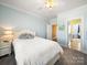 Bright bedroom featuring a white bed, soft colors, and doorway to other rooms at 810 Lake Wright Rd, China Grove, NC 28023