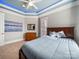 Inviting bedroom features stylish tray ceiling, soft blue lighting, and a relaxing atmosphere, ideal for rest and rejuvenation at 810 Lake Wright Rd, China Grove, NC 28023