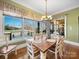 Bright dining area with large windows and outdoor view with a wooden dining table at 810 Lake Wright Rd, China Grove, NC 28023