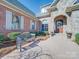 Home exterior with stone entryway, bench, manicured shrubs, and beautiful brick and stone facade at 810 Lake Wright Rd, China Grove, NC 28023