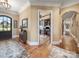 Elegant foyer with hardwood floors, ornate rug, and view into a home office at 810 Lake Wright Rd, China Grove, NC 28023