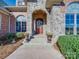 Charming stone entryway featuring a wood door, decorative wreath, potted plants, and stone steps at 810 Lake Wright Rd, China Grove, NC 28023