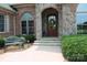 Charming front entrance with stone archway, brick accents, and decorative wreath at 810 Lake Wright Rd, China Grove, NC 28023