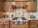 Gourmet kitchen featuring wood cabinets, stainless steel appliances, and a gas range at 810 Lake Wright Rd, China Grove, NC 28023