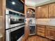 Gourmet kitchen with stainless steel appliances, double oven, wine cooler, and custom cabinetry for sophisticated culinary enthusiasts at 810 Lake Wright Rd, China Grove, NC 28023