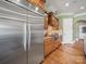 Modern kitchen with stainless steel refrigerator, wooden cabinets, and granite countertops at 810 Lake Wright Rd, China Grove, NC 28023