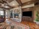 Comfortable living room featuring stone fireplace, hardwood floors, and built-in cabinetry at 810 Lake Wright Rd, China Grove, NC 28023