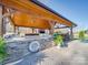 Impressive outdoor kitchen with stone accents, built-in grill, TV, and seating area under a covered patio at 810 Lake Wright Rd, China Grove, NC 28023